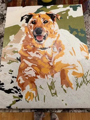 Customer painting a custom paint-by-numbers portrait of a smiling dog